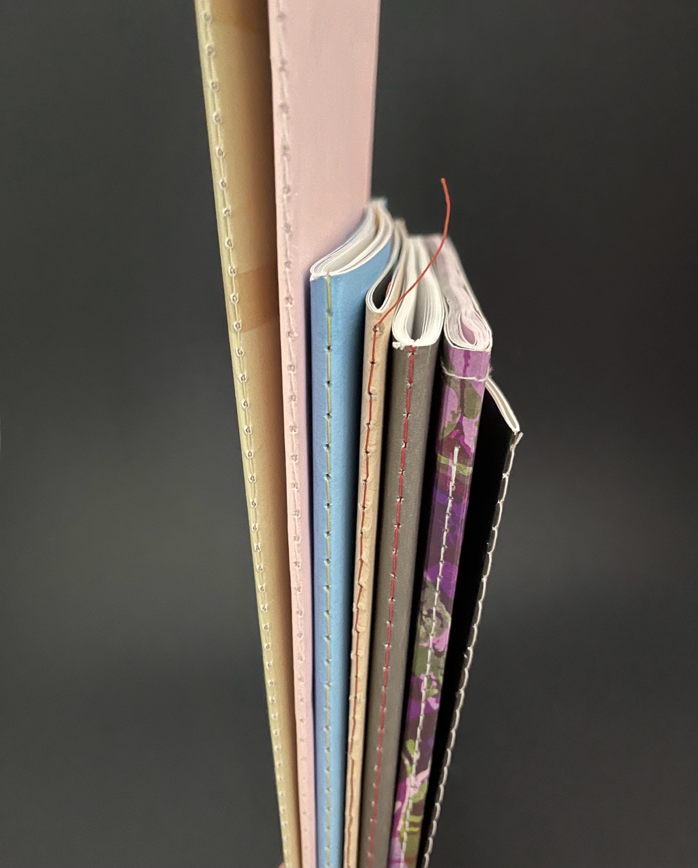 Custom saddle thread sewn softcover notebook printing with visible stitched spine by Printlab Kuala Lumpur